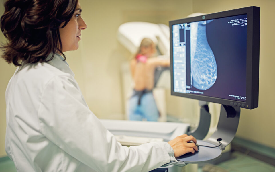 Doctor is working with mammography X-ray scanner in hospital